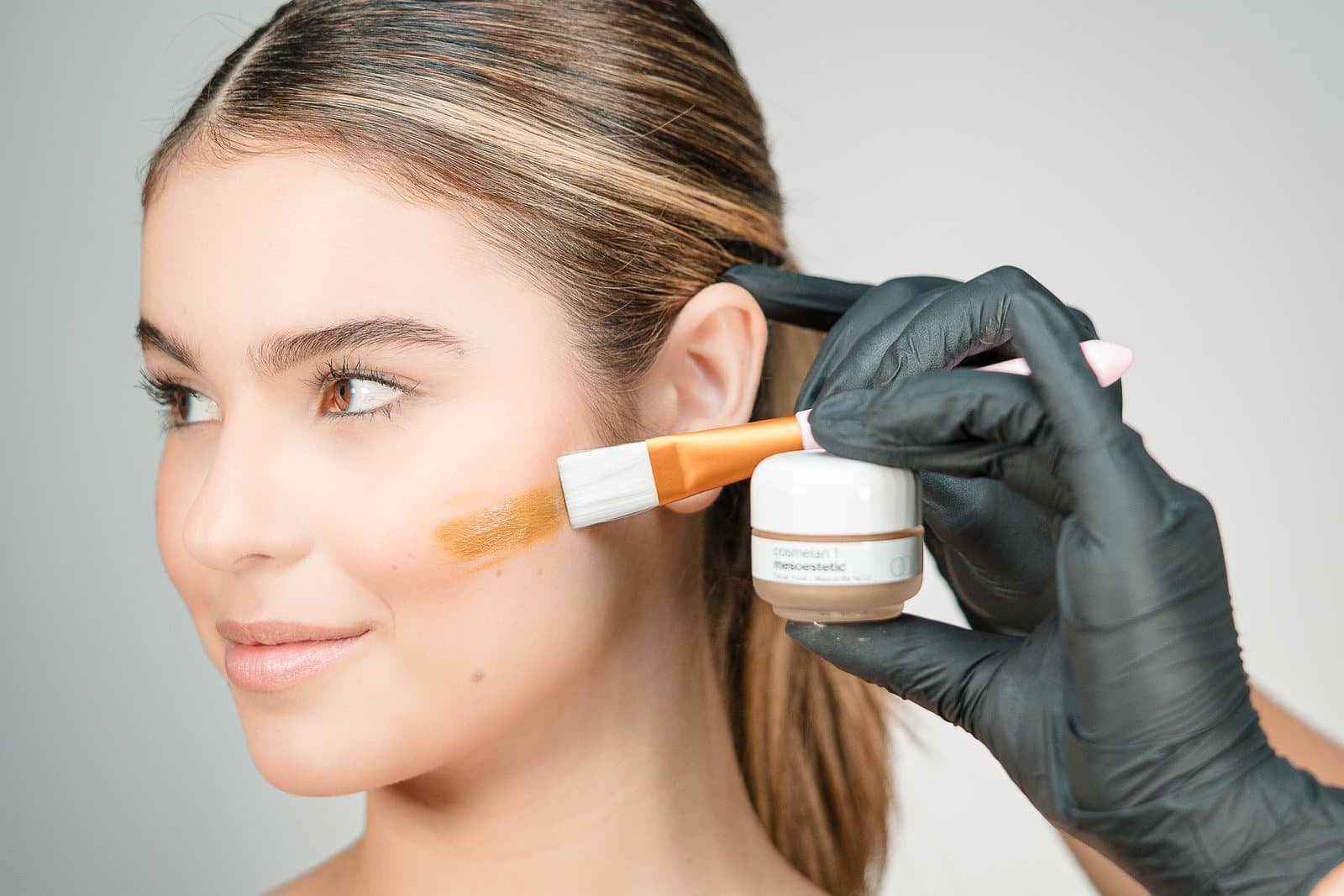 Depigmenting mask being applied with a brush
