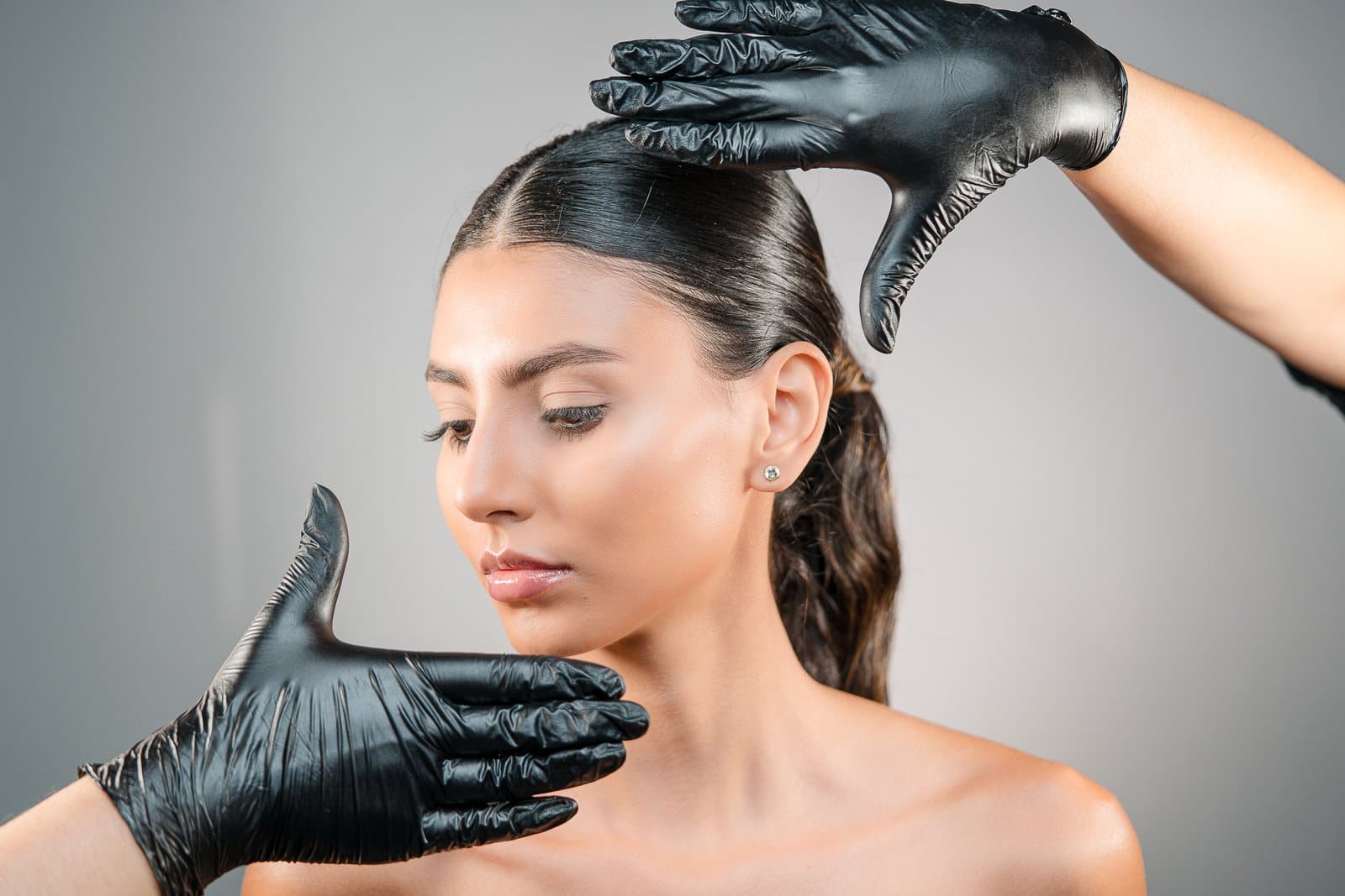 Hands framing the facial contour and double chin
